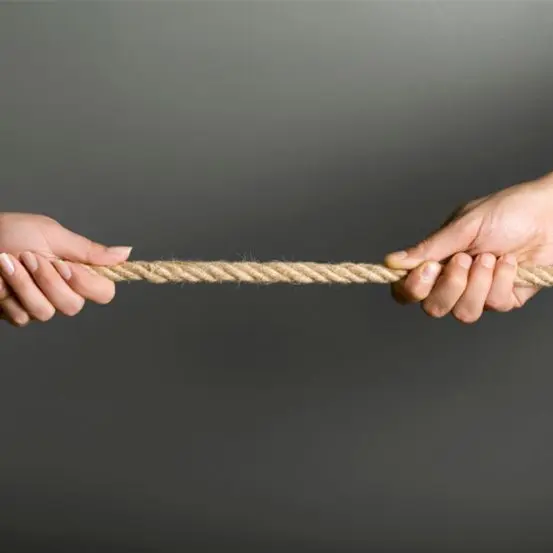 hands pulling either side of rope