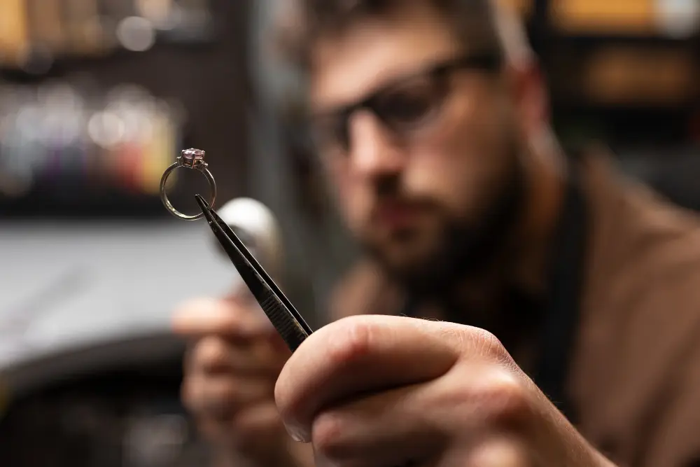 professional jewellery expert valuing ring 