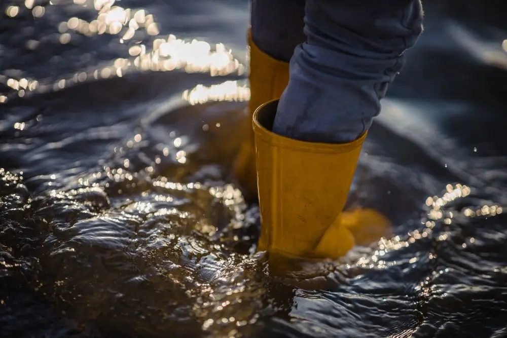 person in wellington boots in flood